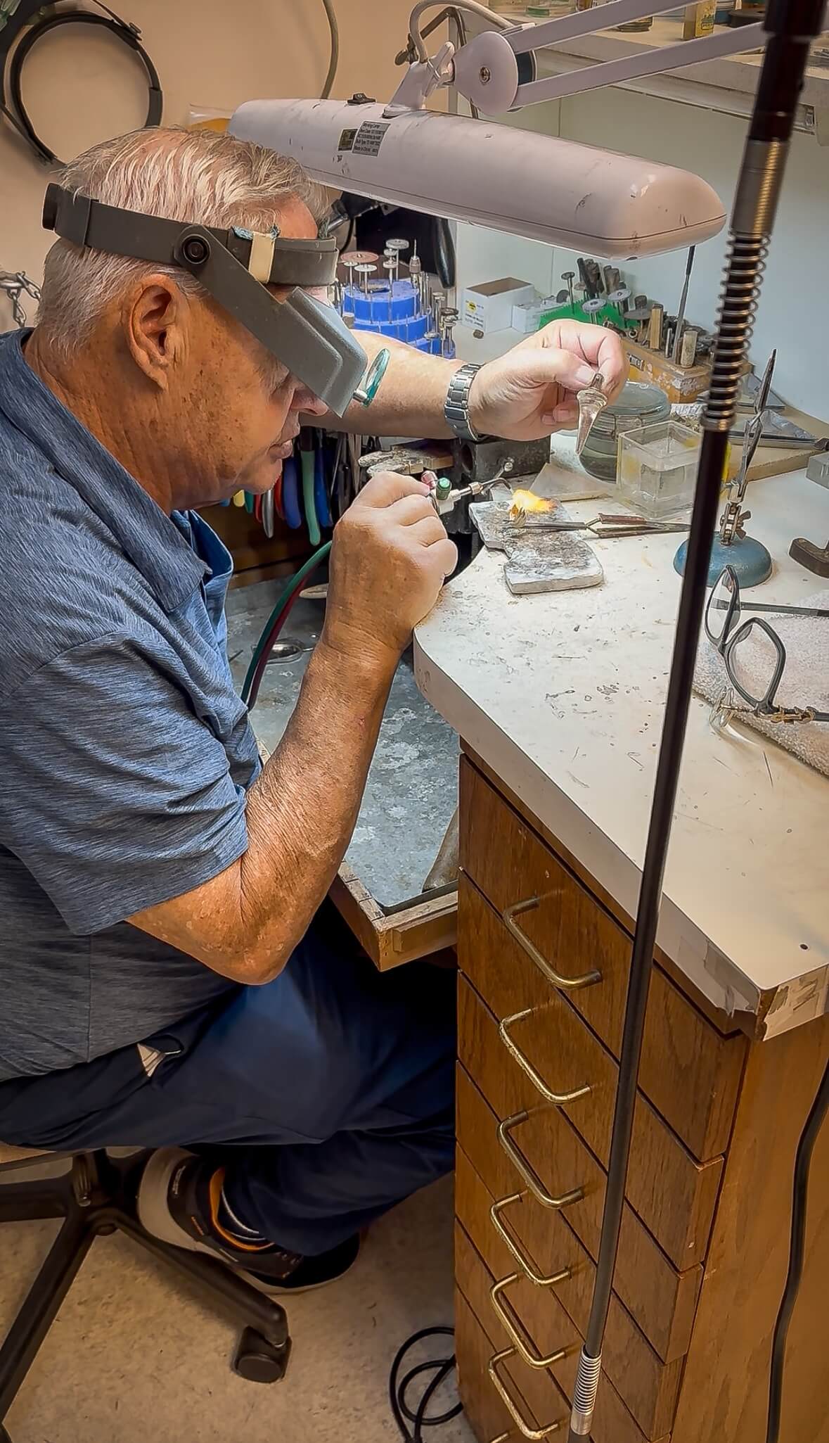 Tom Baggett resizing a gold ring at his workbench — Cranstoun Court Jewellers, Sun City West